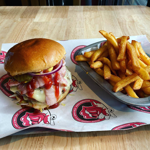 Burger and fries served on a tray with custom printed greaseproof paper